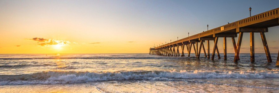 Sunrise over Johnnie Mercers Pier and the Atlantic Ocean at Wrightsville Beach, North Carolina.