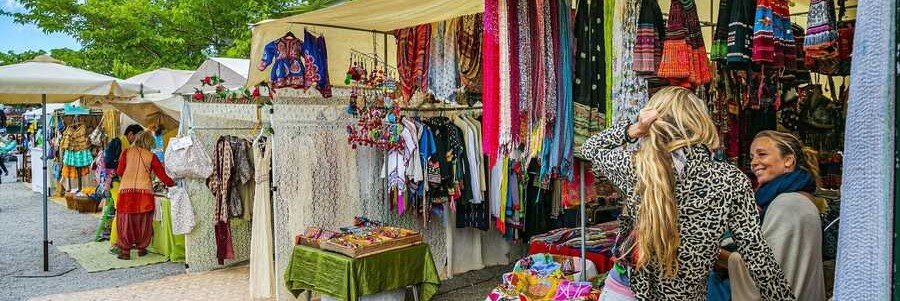 Vibrant clothing stalls and shoppers exploring the traditional Ibiza Hippie Markets