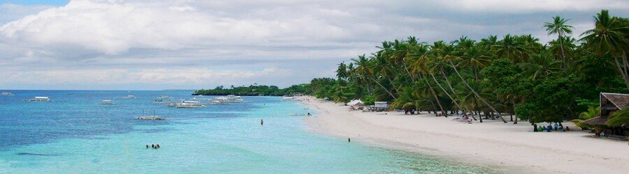 Alona Beach in Panglao with white sand and palm trees