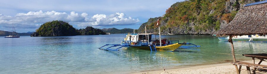 Atwayan Beach in Coron with calm turquoise water and limestone cliffs
