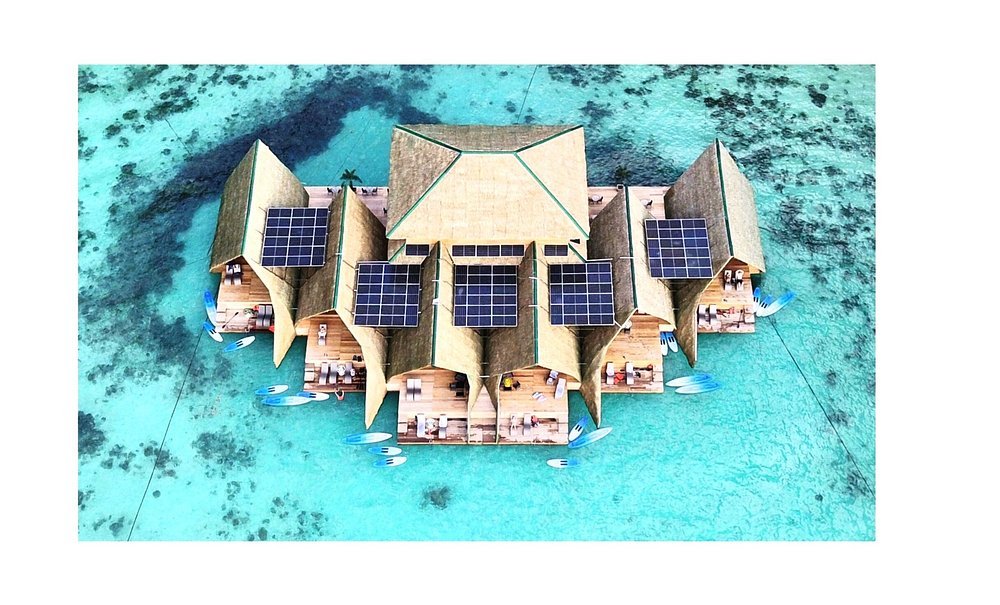 Aerial view of Paolyn Floating House villas above clear turquoise water