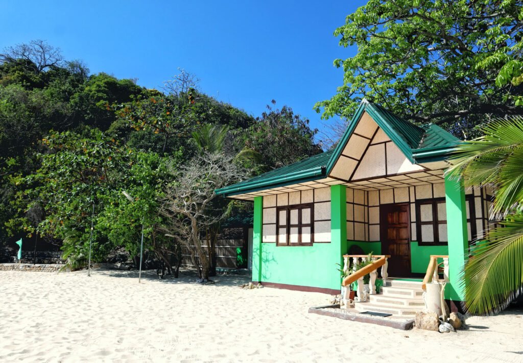 Rock Island Eres Bella island cottage surrounded by sand and tropical trees