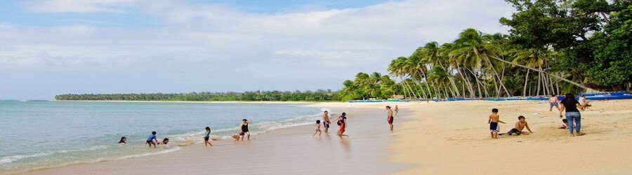 Saud Beach in Pagudpud with palm trees and calm water
