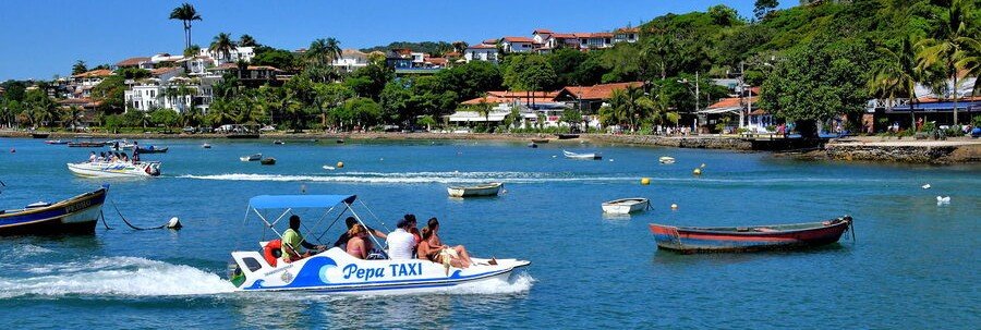 Aqua Taxi Transportation in Búzios Aqua taxi carrying passengers across the calm blue coastal water of Búzios, Brazil.