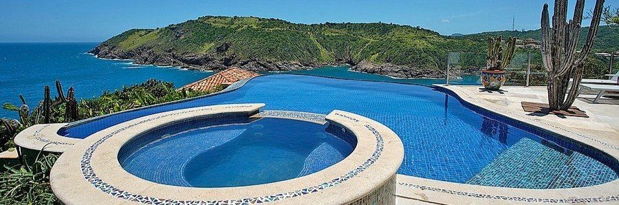Cliffside Luxury Inn Infinity Pool and Ocean View Infinity pool and circular spa overlooking the rocky Atlantic coastline at Cliffside Luxury Inn in Búzios.