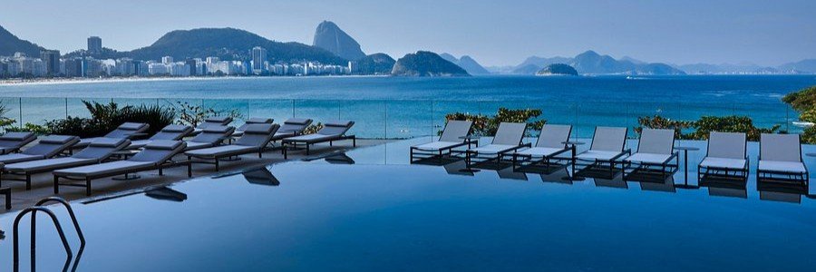 The luxury infinity pool at Fairmont Rio de Janeiro Copacabana overlooking the ocean and Sugarloaf Mountain