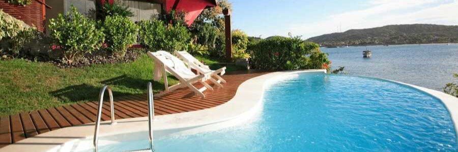 Waterfront Pool at Insolito Boutique Hotel | Beach Travel Destinations Curved waterfront swimming pool with beautiful bay views at Insolito Boutique Hotel in Búzios, Brazil.