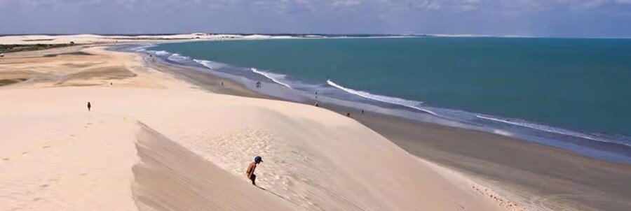 Panorama of the Sunset Dune in Jericoacoara Brazil overlooking a wide sandy beach and turquoise ocean