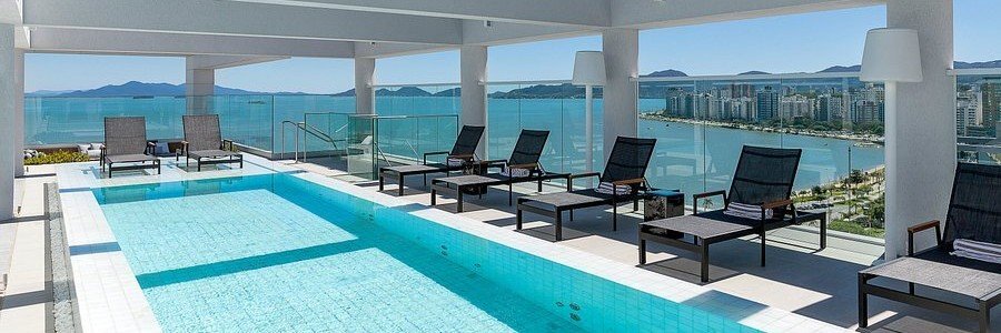 LK Design Hotel Rooftop Pool | Beach Travel Destinations Rooftop swimming pool overlooking the waterfront at LK Design Hotel in Florianópolis.