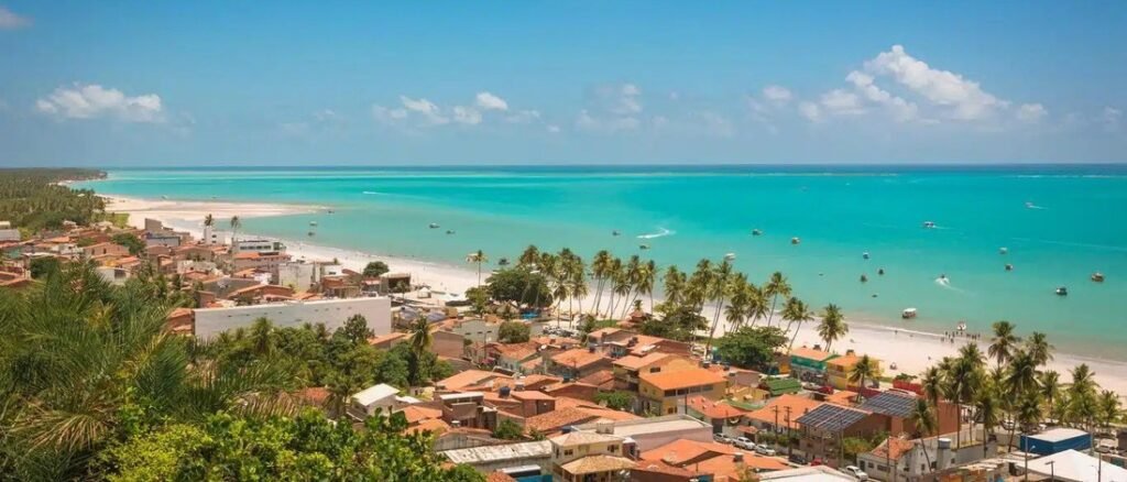 High vantage panorama of Maragogi beachfront town and vibrant turquoise ocean in Alagoas Brazil
