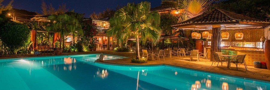 Pedra da Laguna Boutique Hotel Pool at Night | Beach Travel Destinations Evening view of the pool and tropical gardens at Pedra da Laguna Boutique Hotel in Búzios, Brazil.