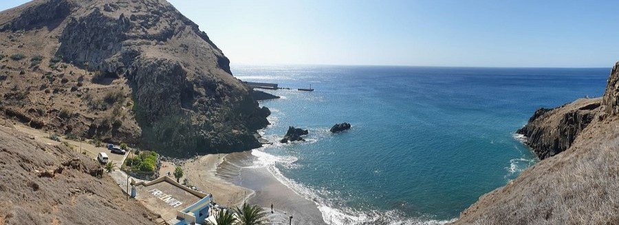 Prainha Beach in Rio de Janeiro surrounded by rocky cliffs and clear Atlantic waters
