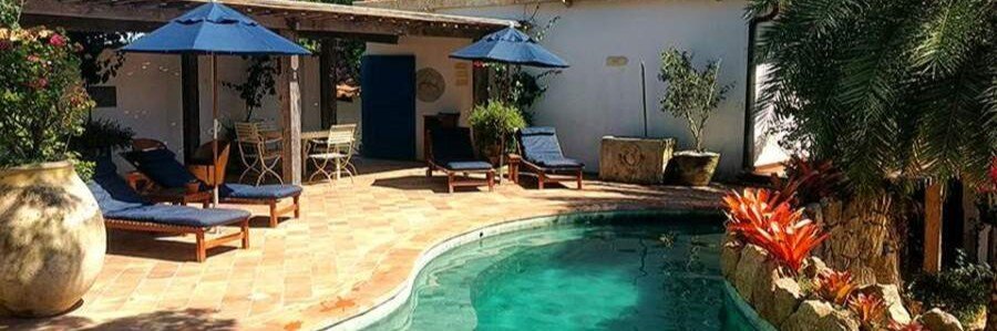 Vila da Santa Hotel Boutique Swimming Pool | Beach Travel Destinations Swimming pool surrounded by tropical gardens at Vila da Santa Hotel Boutique in Búzios, Brazil.