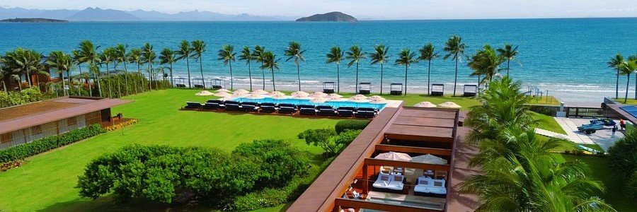 Zendaya Resort Beach Sport & Spa Oceanfront Grounds Oceanfront resort grounds with palm trees, swimming pools, private cabanas, and Atlantic views at Zendaya Resort in Búzios.