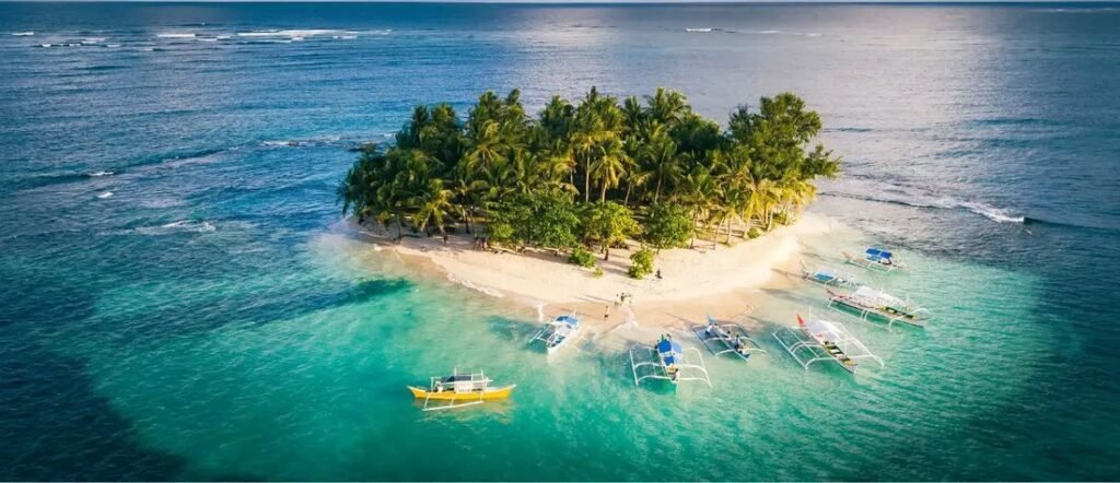 Siargao Island Philippines aerial view with palm trees, white sand, and turquoise water