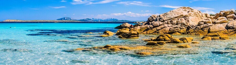 rocky shoreline with clear blue sea in Sardinia