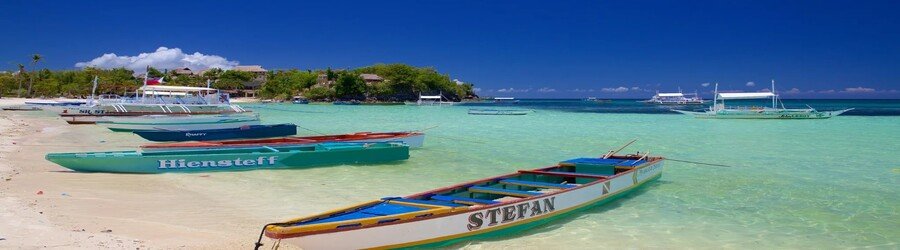 Cebu Island beach with boats, clear turquoise water, and white sand