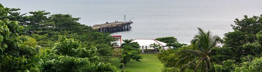 Coastal view of Corregidor Island with pier greenery and historic surroundings