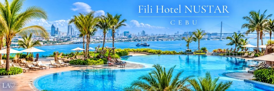 Luxurious waterfront infinity pool surrounded by tropical palm trees, elegant sun loungers, and white umbrellas overlooking a blue harbor, city skyline, and scenic bridge.