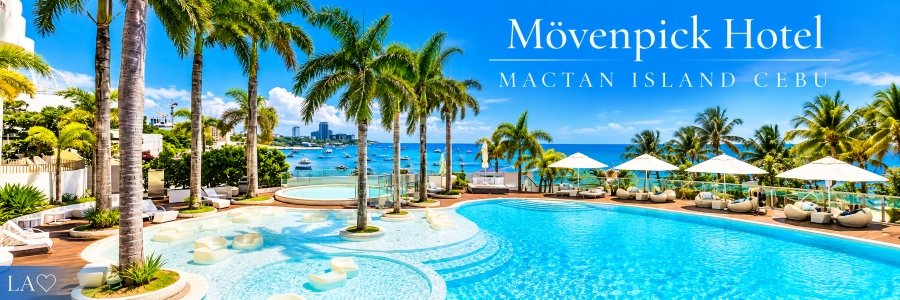 Sparkling turquoise resort swimming pool surrounded by tropical palm trees, white sun loungers, elegant umbrellas, and beautiful ocean views with boats offshore.
