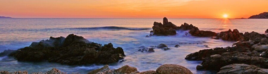 sunset over rocky shoreline in northern Sardinia