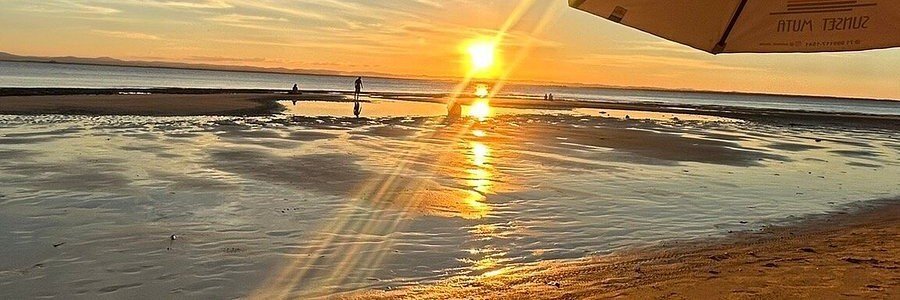 Golden sunset reflecting across the shallow waters at Ponta do Mutá on the Maraú Peninsula.