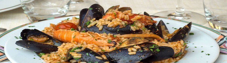 Traditional seafood dish from Stintino with mussels, shrimp, and rice
