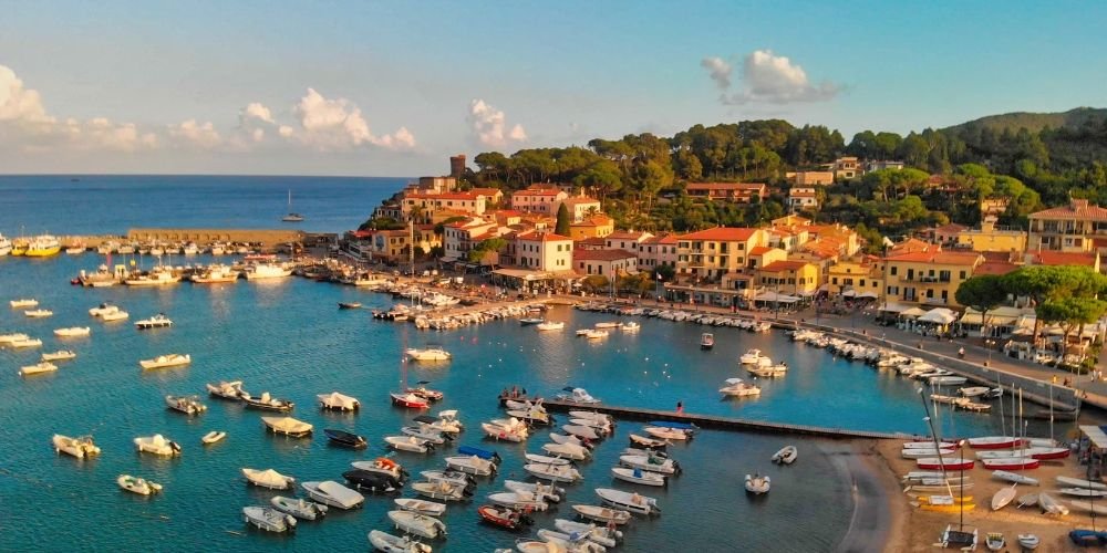 Colorful harbor in Porto Azzurro on Elba Island with boats and seaside village