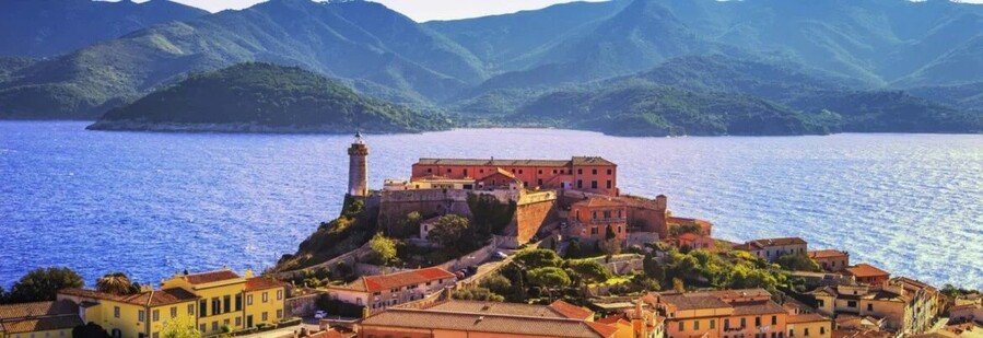Coastal view of Portoferraio on Elba Island with historic fort and blue sea