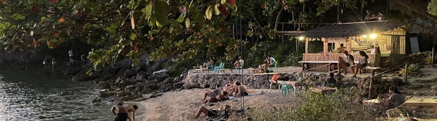 Beach bar on Malapascua Island in the evening with people relaxing