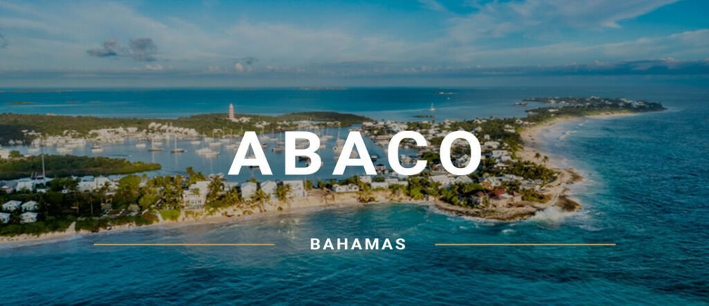 Aerial view of Hope Town and harbor in The Abaco Bahamas, with lighthouse and coastline.