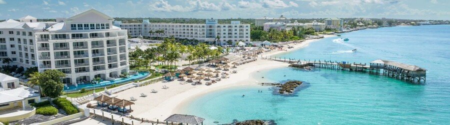 Aerial view of Cable Beach in Nassau with resorts, white sand, and turquoise water.