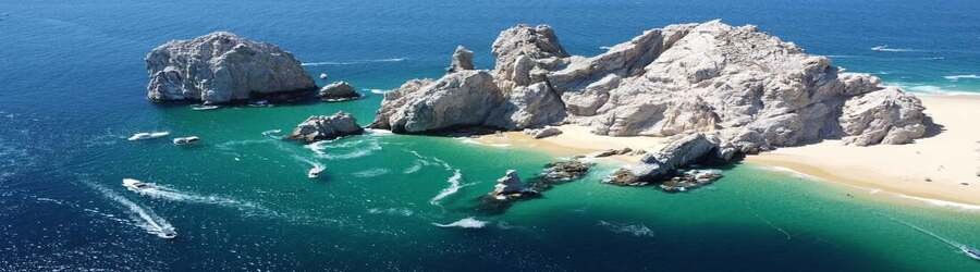 Dramatic rock formations surrounding Lover’s Beach in Cabo San Lucas, one of Mexico’s most romantic seaside escapes.