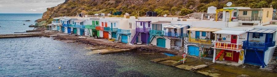 Experience the charm of Milos fishing villages with whitewashed houses set against the Aegean Sea.