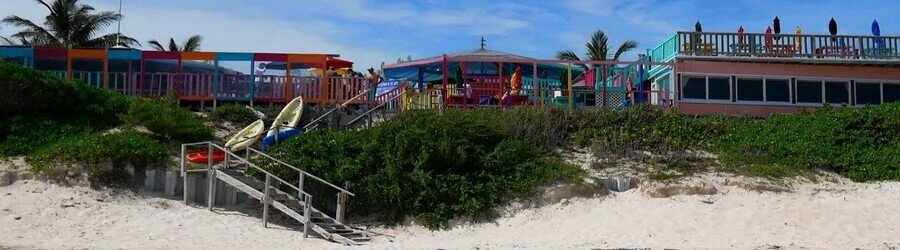 Colorful Nippers Beach Bar and Grill overlooking the beach on Great Guana Cay.