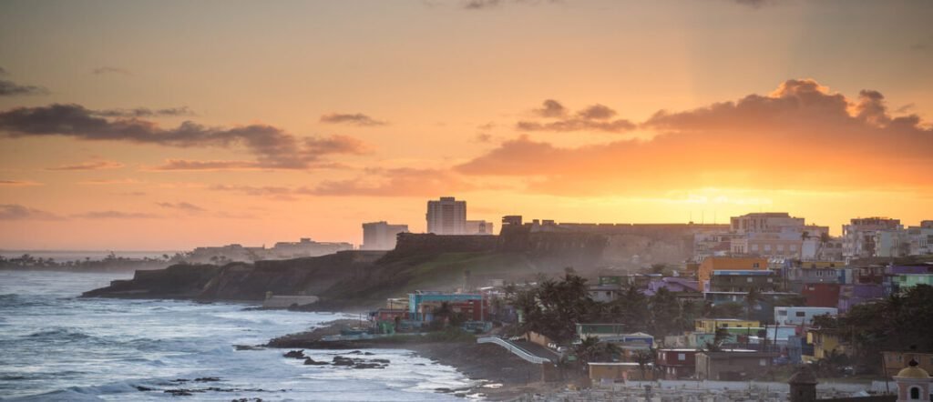 Sunset over the colorful coastline of San Juan Puerto Rico with waves crashing on the shore