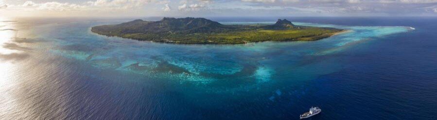 Austral Islands aerial view with lagoon, reef, and remote island coastline