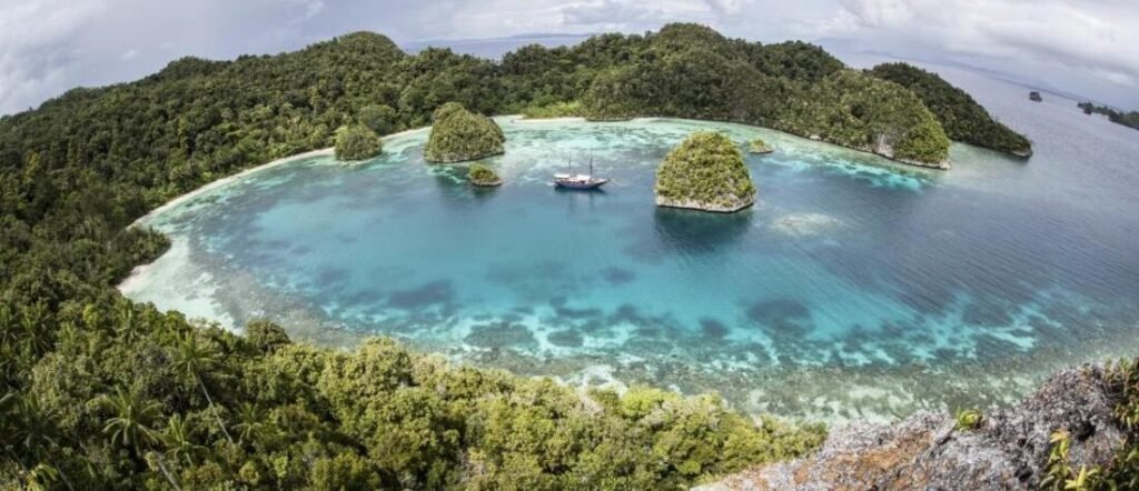 Aerial view of a lagoon in the Austral Islands with small tropical islets and clear blue water