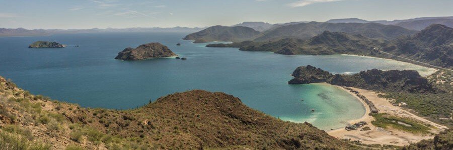 Panoramic view of Bahía Concepción in Baja Mexico, showing multiple coves, turquoise water, and rugged desert hills