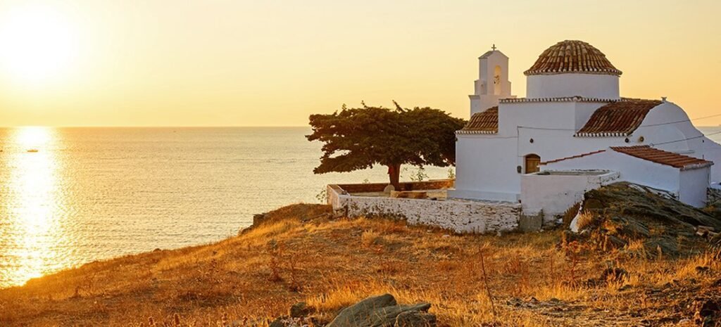 Whitewashed chapel on Beautiful Kythnos at sunset, Cyclades, overlooking the Aegean Sea.