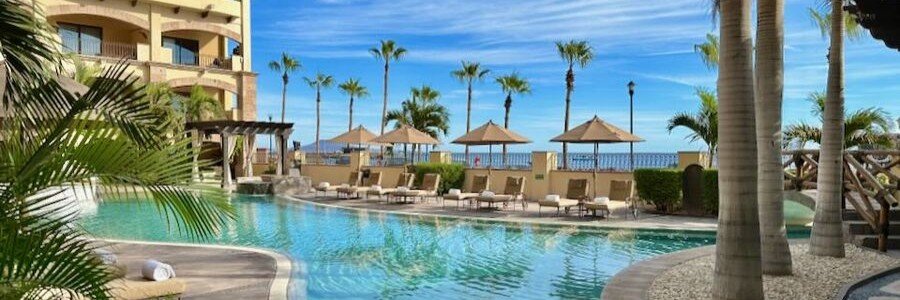 bugambilias-suites-loreto-charming-courtyard-pool-stay | Beach Travel Destinations Bugambilias Suites hotel in Loreto, Mexico featuring a traditional courtyard with a small pool, palm trees, lounge chairs, and warm-toned architecture creating a relaxing and charming setting