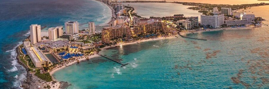Cancun Hotel Zone Aerial View | Beach Travel Destinations Aerial view of Cancun Hotel Zone with turquoise Caribbean water and beachfront resorts.