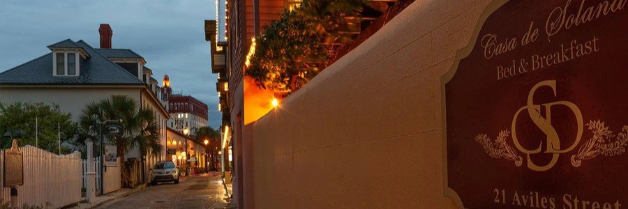 Casa De Solana Bed & Breakfast in historic St Augustine featuring Aviles Street, charming architecture, and evening lights.