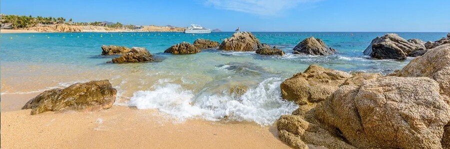 Cabo Beaches at Chileno Beach with turquoise water, golden sand, and rocky formations