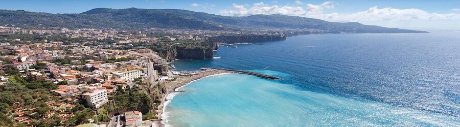 Aerial view of a coastal town and turquoise bay near Naples