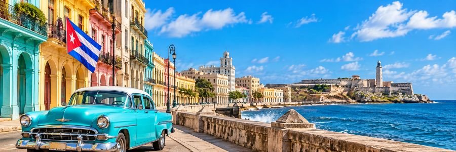 Turquoise vintage American car along Havana's waterfront, with colorful colonial buildings, a Cuban flag, and the historic seaside fortress.
