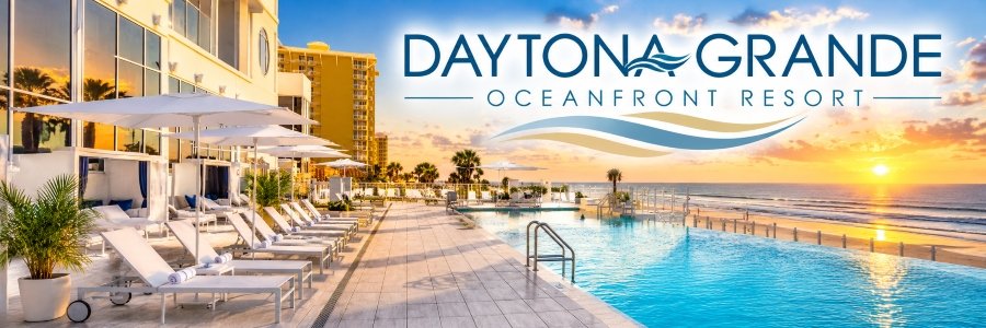 Elegant infinity pool overlooking the ocean at sunset, with white lounge chairs, umbrellas, and a spacious poolside terrace.