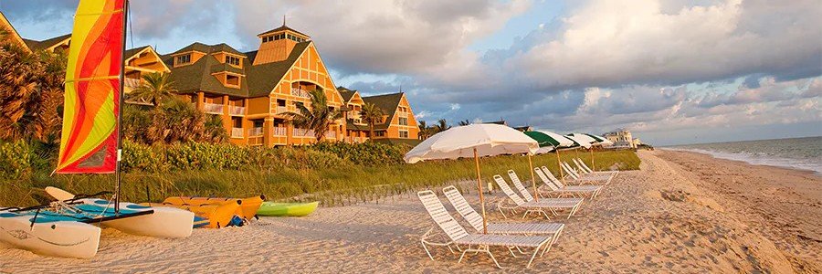 Disney's Vero Beach Resort | Beach Travel Destinations Disney's Vero Beach Resort with beach chairs, sailboats, and a sandy Atlantic shoreline in Florida.