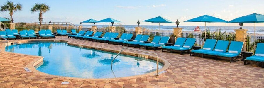 Oceanfront swimming pool at Dune House Hotel & Spa with lounge chairs overlooking the Atlantic Ocean.