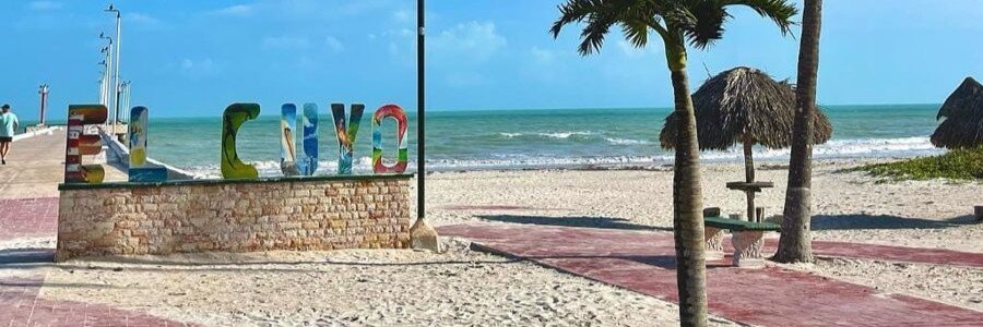 Colorful El Cuyo sign beside the sandy beach on Mexico's Yucatán coast. | Beach Travel Destinations Colorful El Cuyo sign beside the sandy beach on Mexico's Yucatán coast.